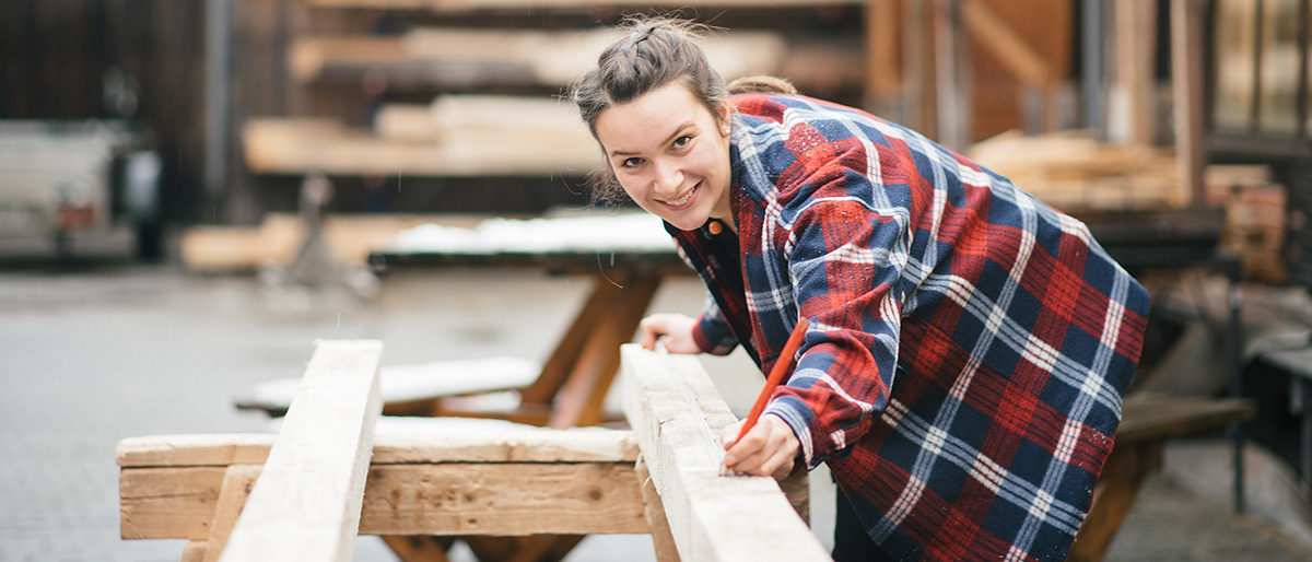 Junge Frau bei der Arbeit in einer Zimmerei. Junge Frau bei der Arbeit in einer Zimmerei.