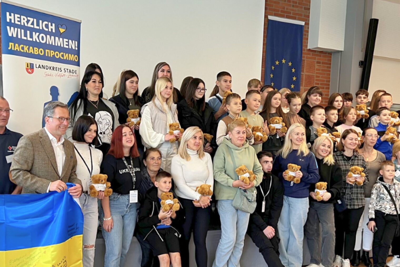Teilnehmergruppe der Ukraine-Kinderfreizeit im TZH Stade Gruppenfoto der Teilnehmerinnen und Teilnehmer der Ukraine-Kinderfreizeit 2025 im Technologiezentrum Stade mit Willkommensbanner